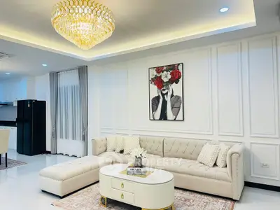 Luxurious living room with elegant chandelier and plush sectional sofa