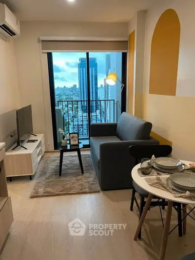 Modern living room with city view, stylish decor, and cozy seating area.