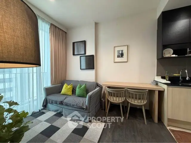 Modern living room with cozy sofa, dining area, and stylish decor in a contemporary apartment.