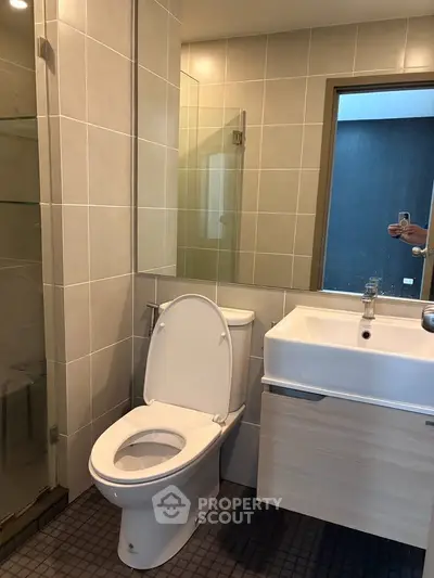 Modern bathroom with sleek fixtures and glass shower enclosure