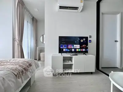 Modern bedroom with sleek TV setup and stylish decor