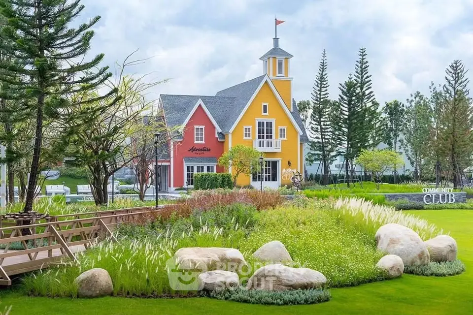 Charming community clubhouse with vibrant colors and lush landscaping