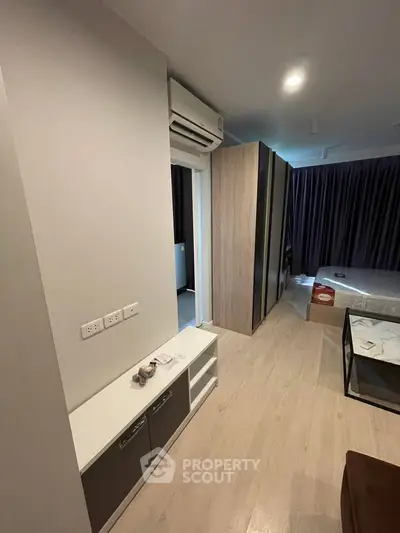 Modern bedroom with sleek design, featuring built-in wardrobe and air conditioning for ultimate comfort.