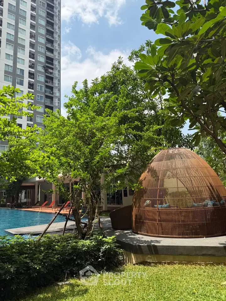 Luxurious apartment complex with pool and lush greenery, perfect for relaxation and modern living.