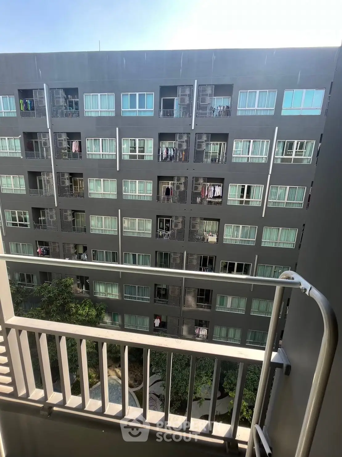 Modern apartment building view from balcony with sleek design and urban living appeal.