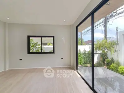 Spacious modern living room with large windows and garden view