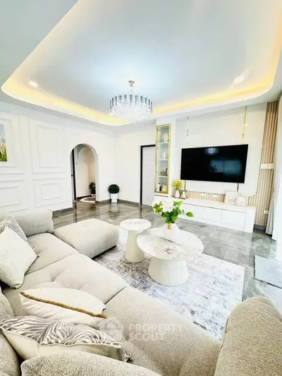 Luxurious living room with elegant decor, plush sofa, and modern lighting in a stylish home.