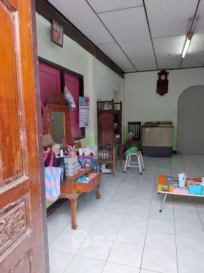 Charming interior space with vintage furniture and tiled flooring, perfect for cozy living.