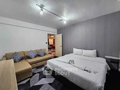 Modern bedroom with stylish decor and comfortable seating area