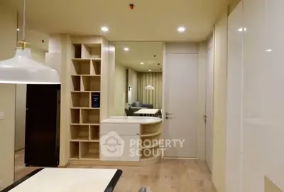 Modern interior with sleek storage and stylish lighting in a contemporary apartment.