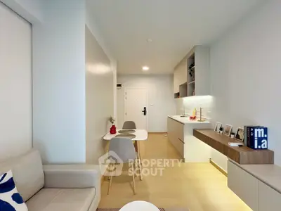 Modern open-layout living room with sleek kitchen and stylish decor