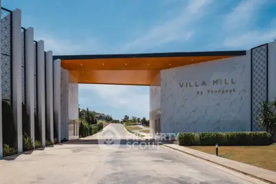 Luxurious entrance of Villa Hill with modern architecture and scenic driveway