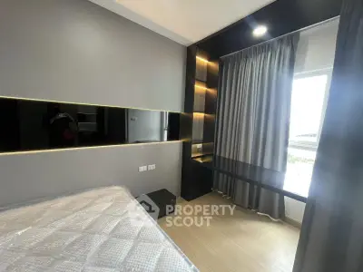 Modern bedroom with sleek design, featuring a large window and stylish built-in shelving.