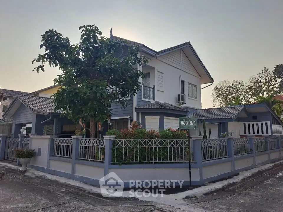 Charming corner unit house with lush garden and modern exterior design in a serene neighborhood.