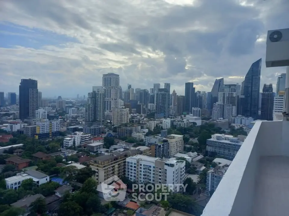Stunning cityscape view from a high-rise balcony overlooking urban skyline.