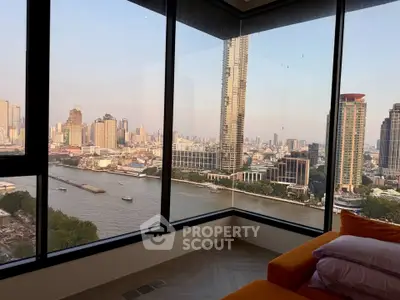 Stunning corner unit with panoramic city and river views from a high-rise apartment.