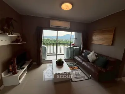 Cozy living room with mountain view and balcony access