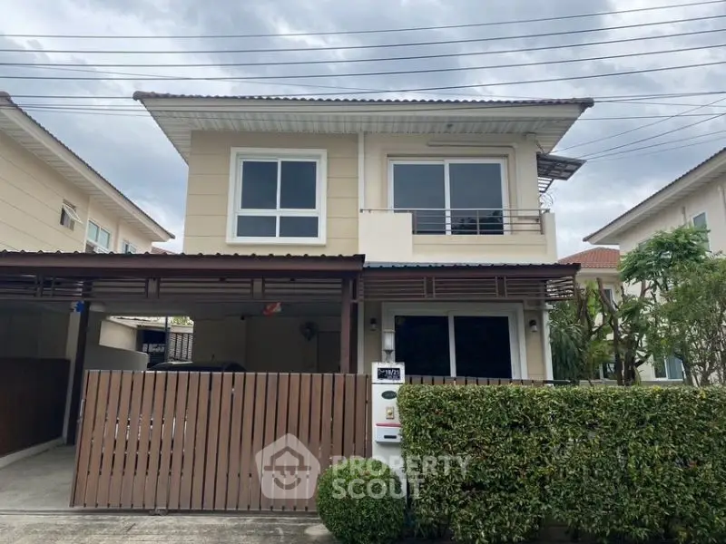 Charming two-story house with modern facade and lush greenery in a serene neighborhood.