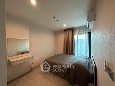 Cozy modern bedroom with natural light and stylish decor in a contemporary apartment.