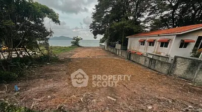 Scenic beachfront property with lush greenery and ocean view, ideal for development.