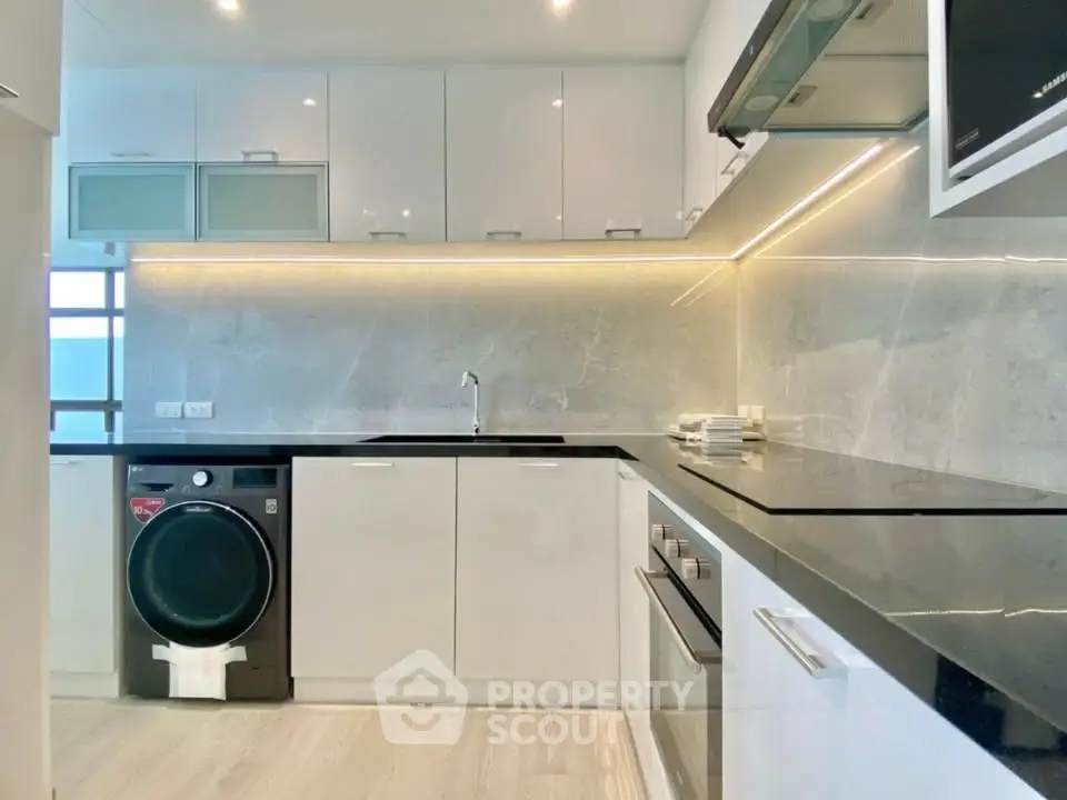 Modern kitchen with sleek cabinetry, built-in appliances, and elegant lighting.