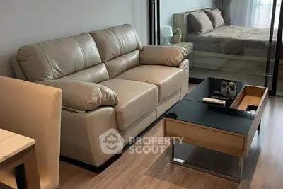 Modern living room with leather sofa and sleek coffee table in stylish apartment.
