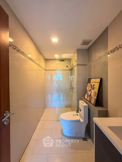 Modern bathroom with sleek design and elegant fixtures, featuring a spacious shower area and contemporary decor.