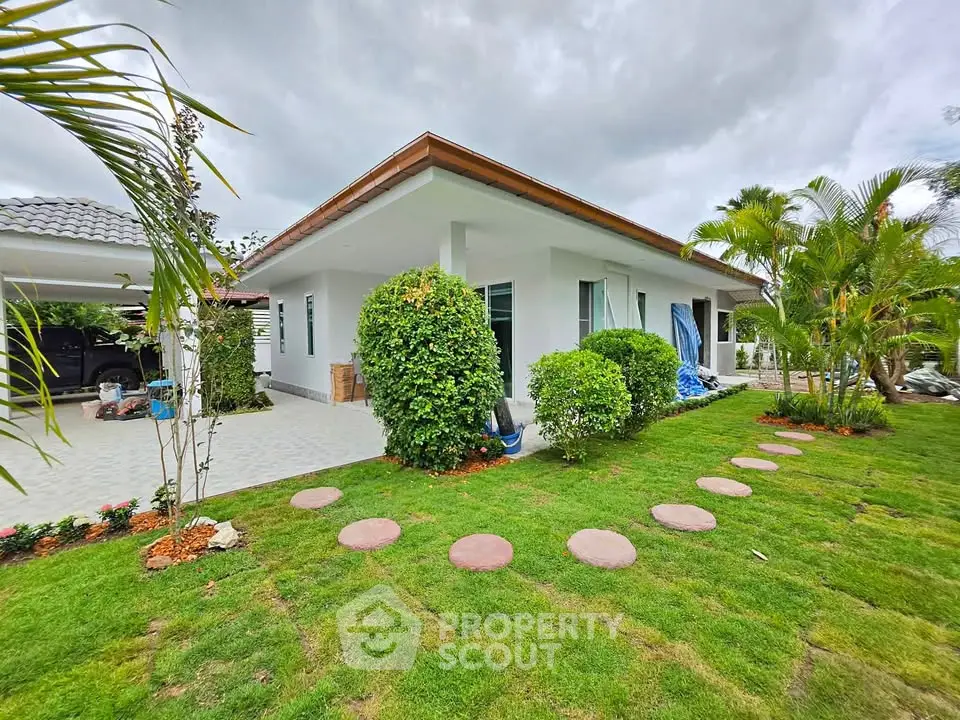 Charming single-story home with lush garden and modern exterior design, perfect for family living.