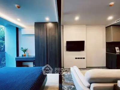 Modern studio apartment with sleek design, featuring a cozy bedroom and stylish living area.