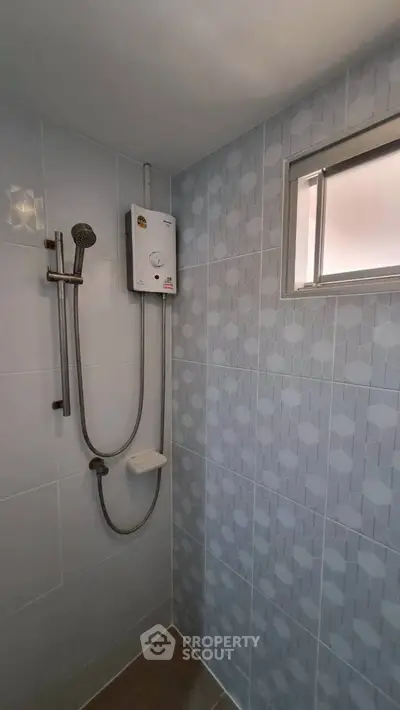 Modern bathroom with sleek shower and geometric tile design