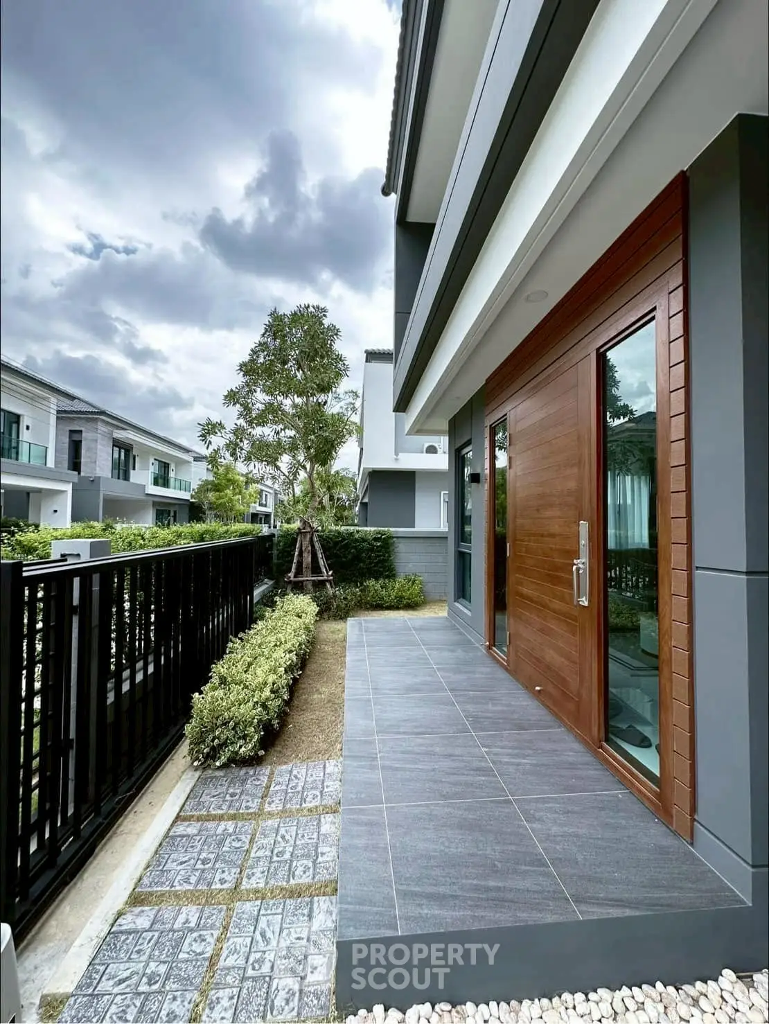 Modern townhouse exterior with sleek design and spacious patio