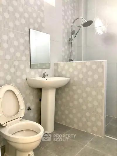Modern bathroom with geometric tile design and sleek fixtures