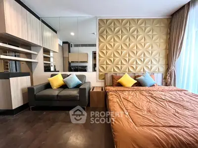 Modern bedroom with stylish decor and cozy seating area, featuring elegant wood finishes and vibrant cushions.