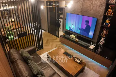 Modern living room with stylish decor and large TV, featuring open layout and elegant lighting.