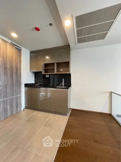 Modern kitchen with sleek cabinetry and open layout in a contemporary apartment.