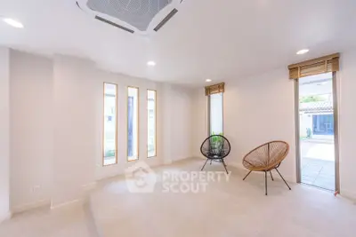 Spacious modern living room with minimalist design and large windows