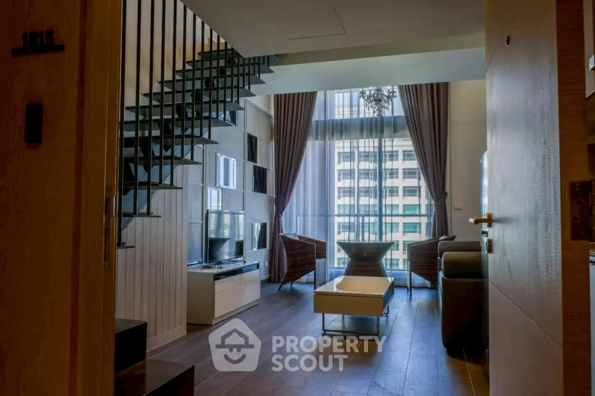 Luxurious living room with high ceilings and modern decor in urban apartment.