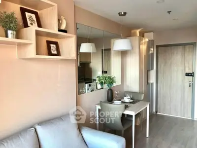Modern living room with stylish decor and dining area in a cozy apartment.