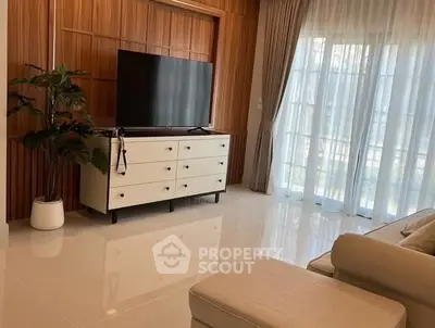 Modern living room with sleek TV setup and elegant curtains