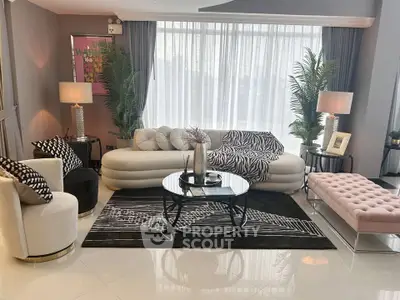 Luxurious modern living room with elegant furniture and large windows