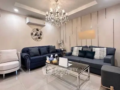 Elegant living room with modern chandelier and stylish furniture