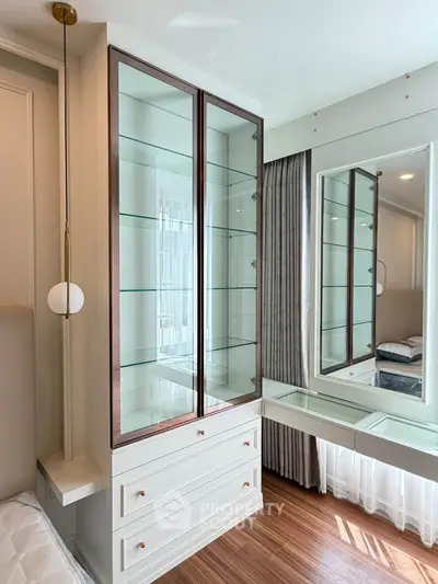 Elegant bedroom with glass display cabinet and modern decor