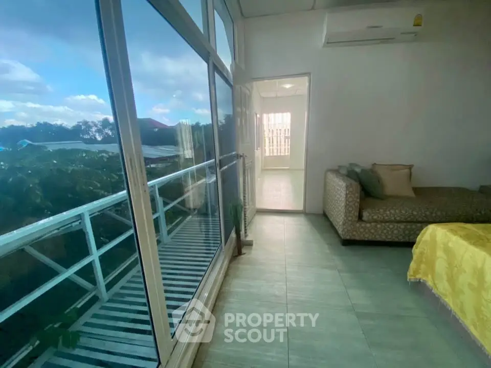 Spacious living room with large windows offering a stunning view and abundant natural light.