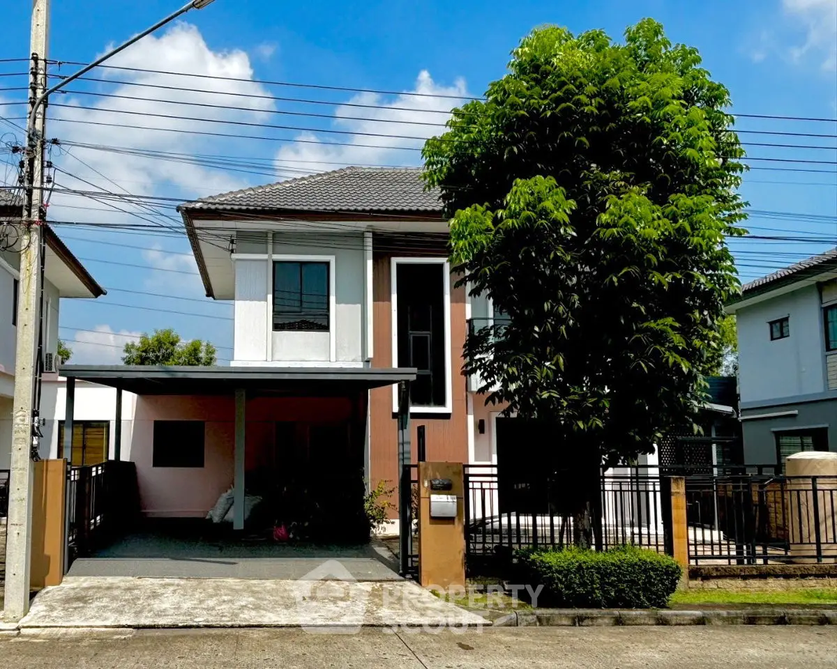 Charming two-story house with modern design and spacious driveway in a serene neighborhood.