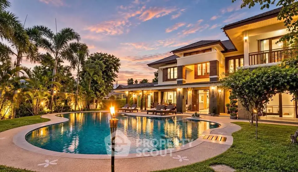 Luxurious villa with stunning pool and lush garden at sunset, perfect for serene living.