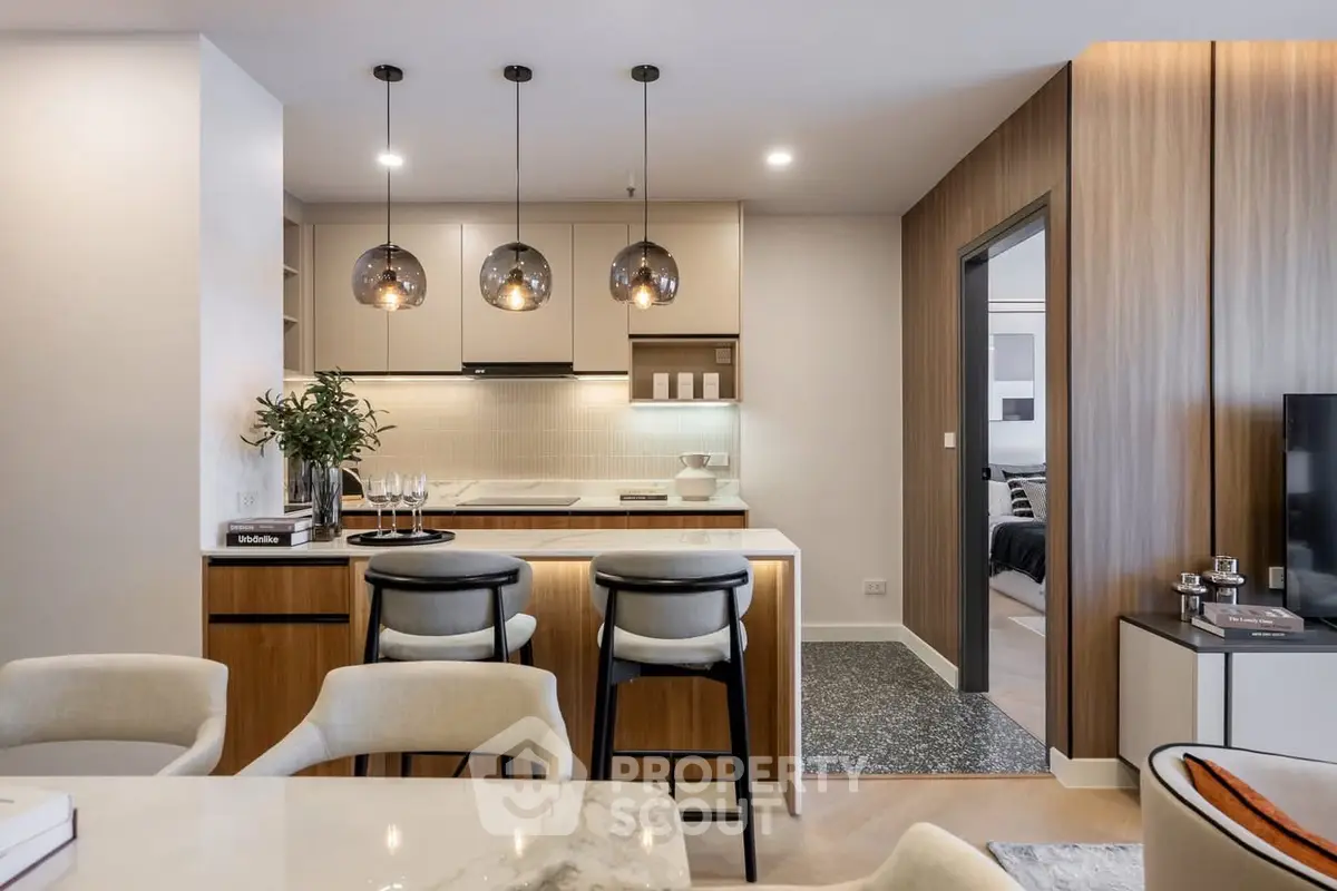 Modern open-plan kitchen and dining area with stylish lighting and contemporary decor.