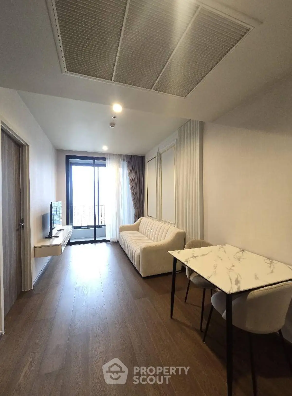 Modern living room with elegant decor and balcony view