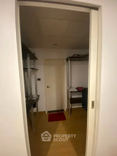 Cozy bedroom with bunk bed and study desk, ideal for compact living spaces.