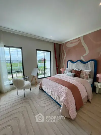 Chic bedroom with stylish decor and large windows offering scenic views, perfect for modern living.