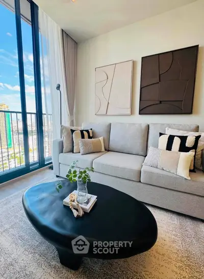 Modern living room with stylish decor and city view from large windows.